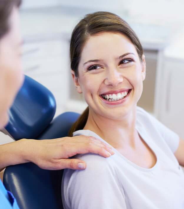 smiling woman sitting in a dental chair